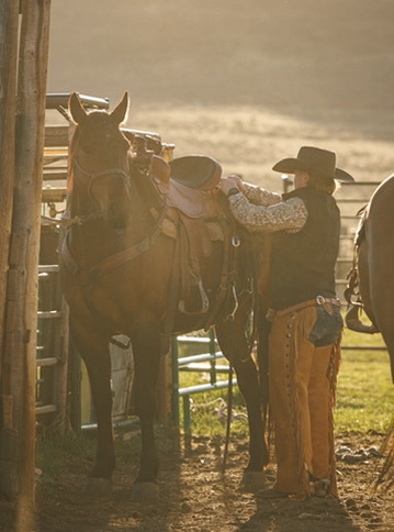 Saddling a horse at the ranch
