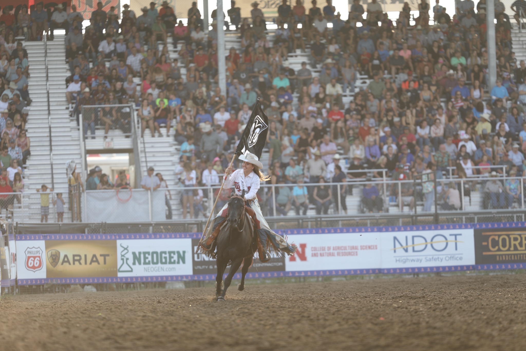 Horsewoman carrying a rodeo flag